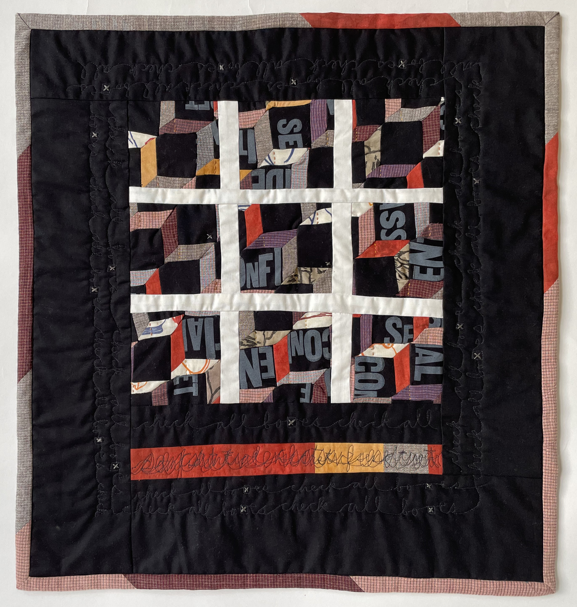 pieced quilt divided into a grid of nine squares