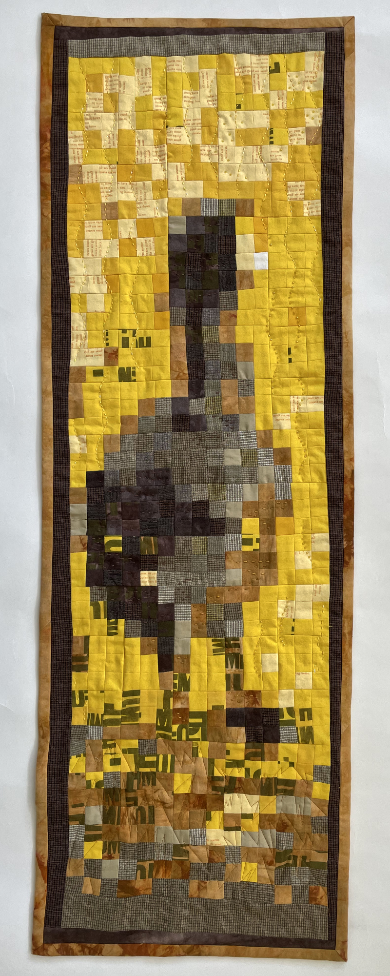 pieced quilt with squares that make up an American coot looking over its shoulder