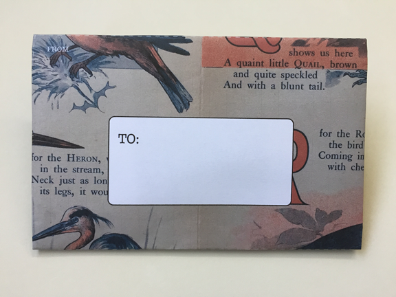 front of envelope printed with old book design on standard printer paper