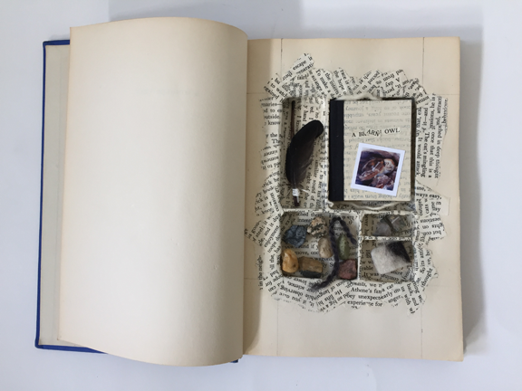 carved book with compartments and objects