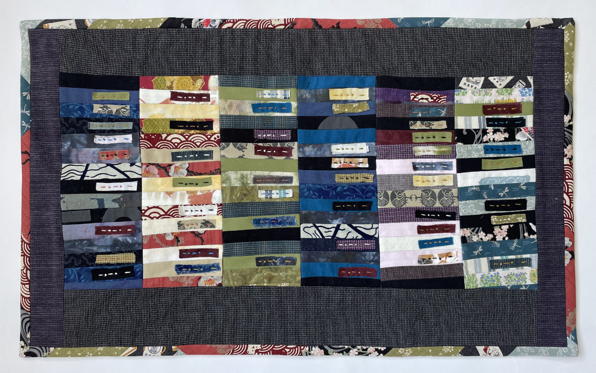 quilt of pieced and stacked horizontal rectangles 15 high by 6 wide with inset stitched raw edge rectangles