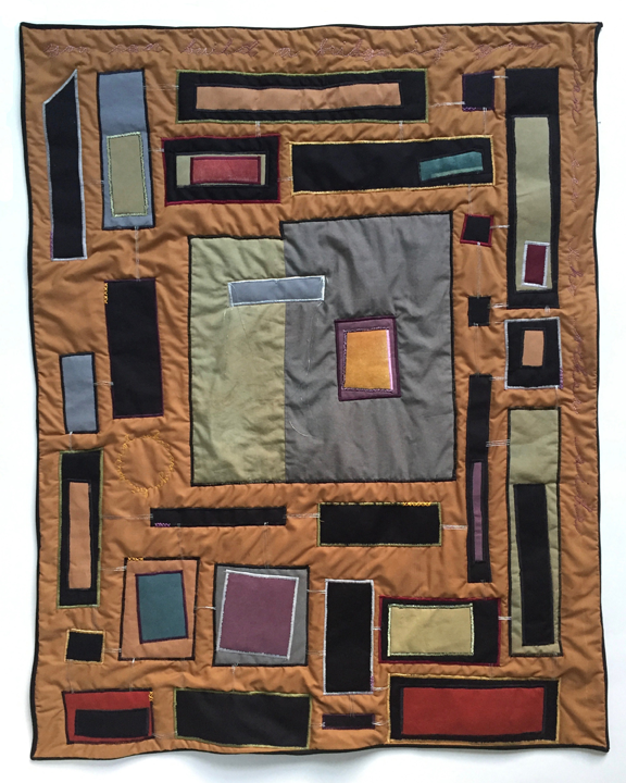 quilt of multicolored rectangles connected with silver threads and embroidered text