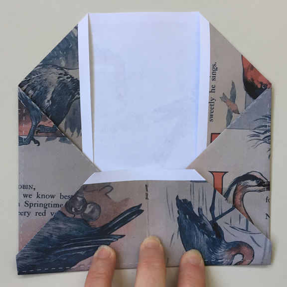 bottom edge folded up and overlapping the right and left folded points