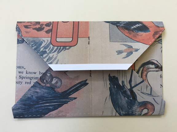 top edge folded down and overlapping bottom flap about one half inch