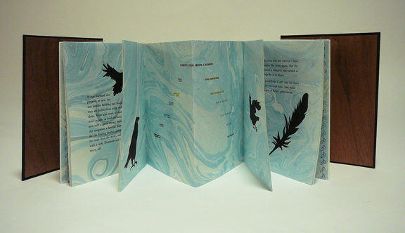 hardcover accordion-fold book with ravens