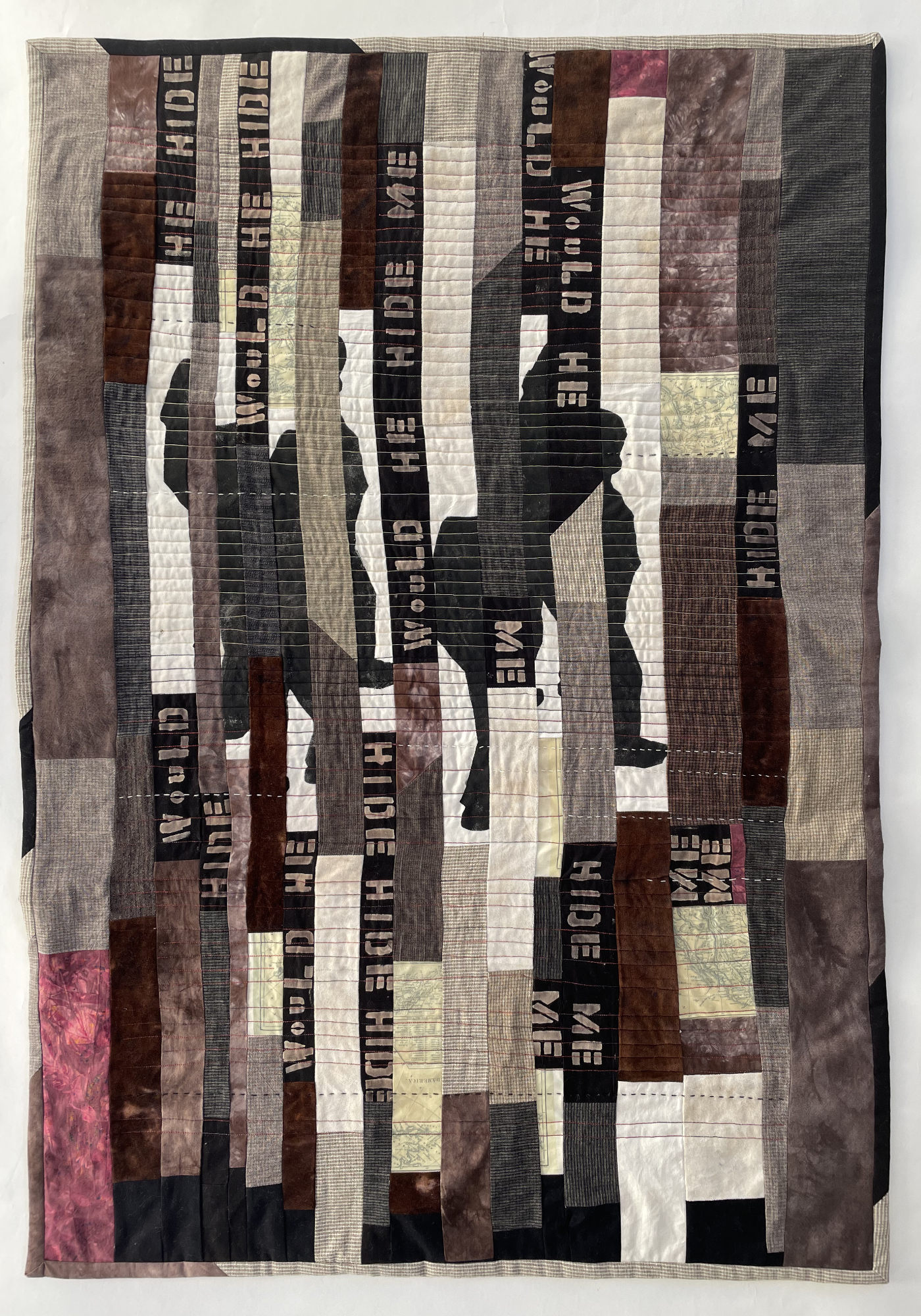 pieced quilt vertical strips of a silhouette interspersed with the words of the title and quilted in horizontal lines